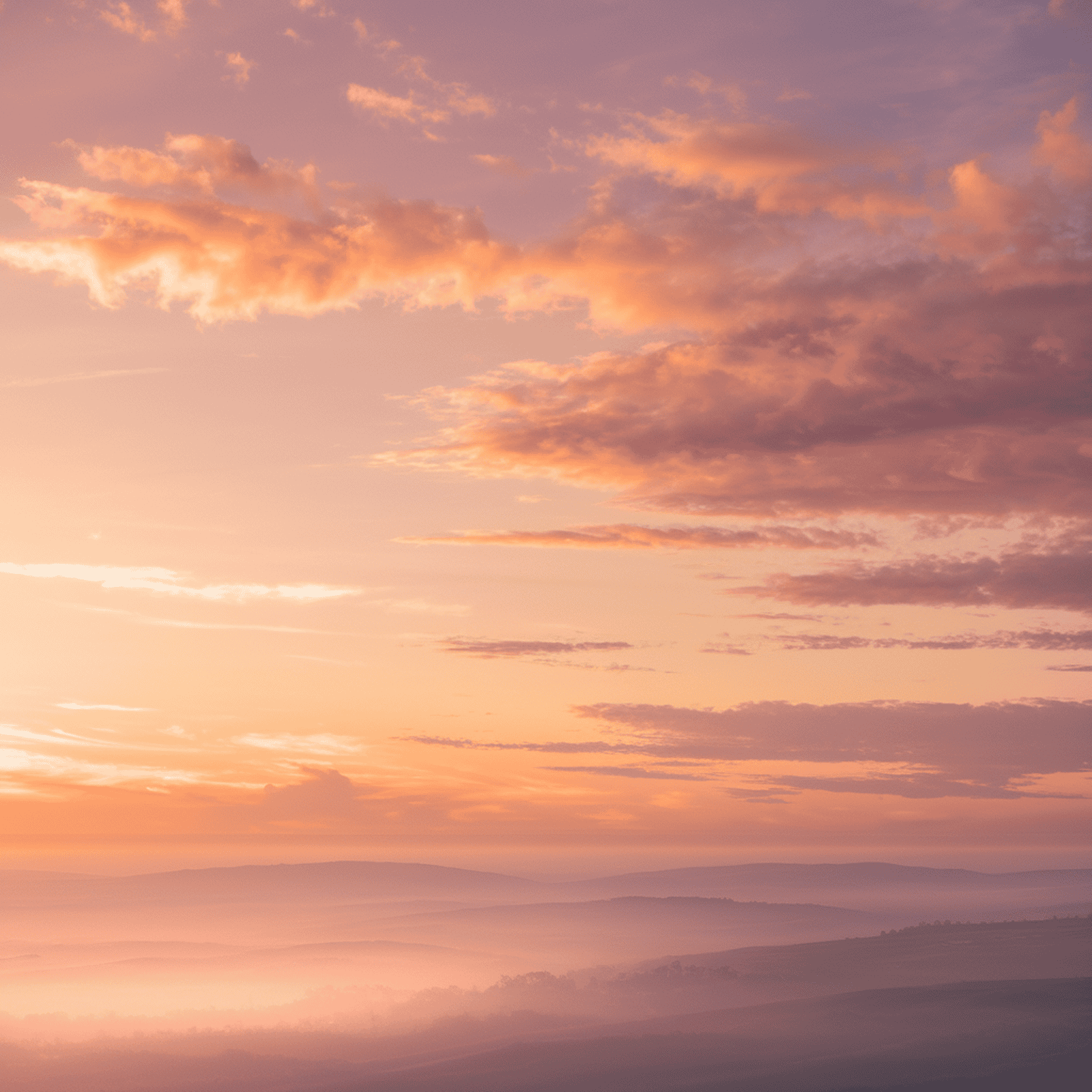 A peaceful sunrise over soft hills and clouds, symbolizing calm reflection and planning for the future in a post about what is an advance directive.